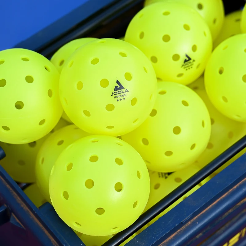 a group of yellow balls in a blue box